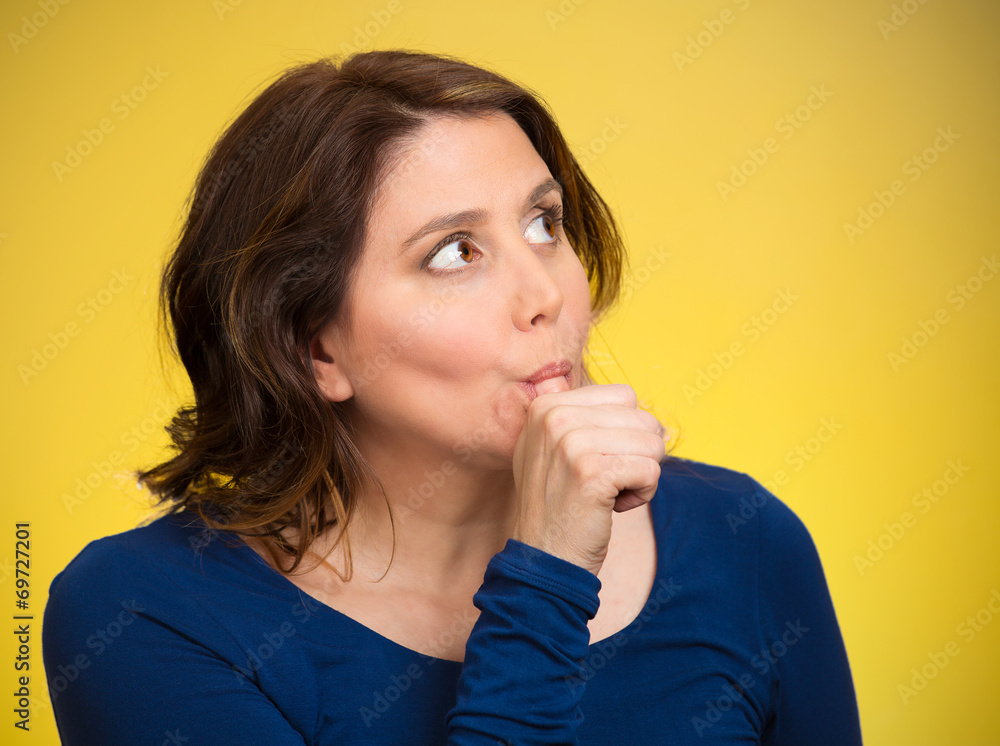 Woman with finger in mouth, sucking thumb, procrastinating Woman with finger in mouth, sucking thumb, procrastinating