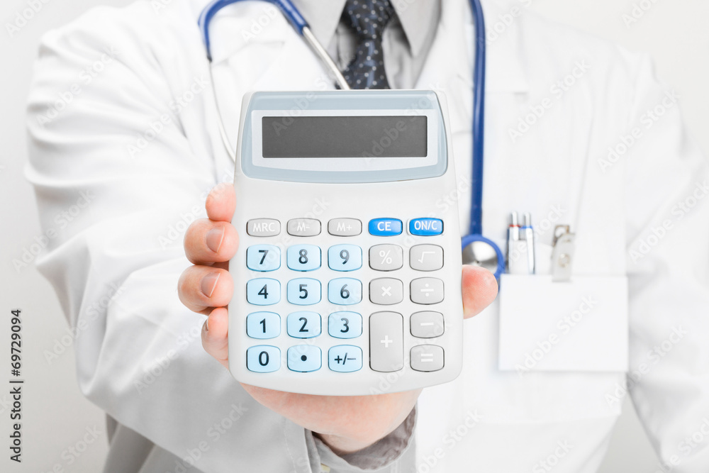 Doctor holdling in his hand calculator - studio shoot Doctor holdling in his hand calculator - studio shoot