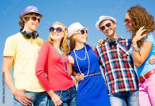group of young people wearing sunglasses and hat