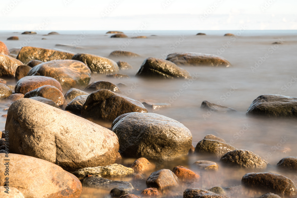 Fototapeta premium View of a rocky coast in the morning. Long exposure shot.
