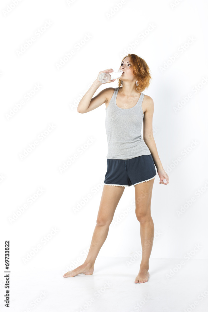 Young skinny girl drinks water in the morning