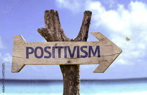 Positivism wooden sign with a beach on background photo