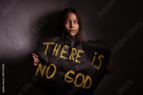 Atheist teen girl holding a banner with the inscription photo