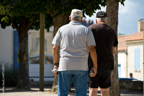 Two old men walking in the street