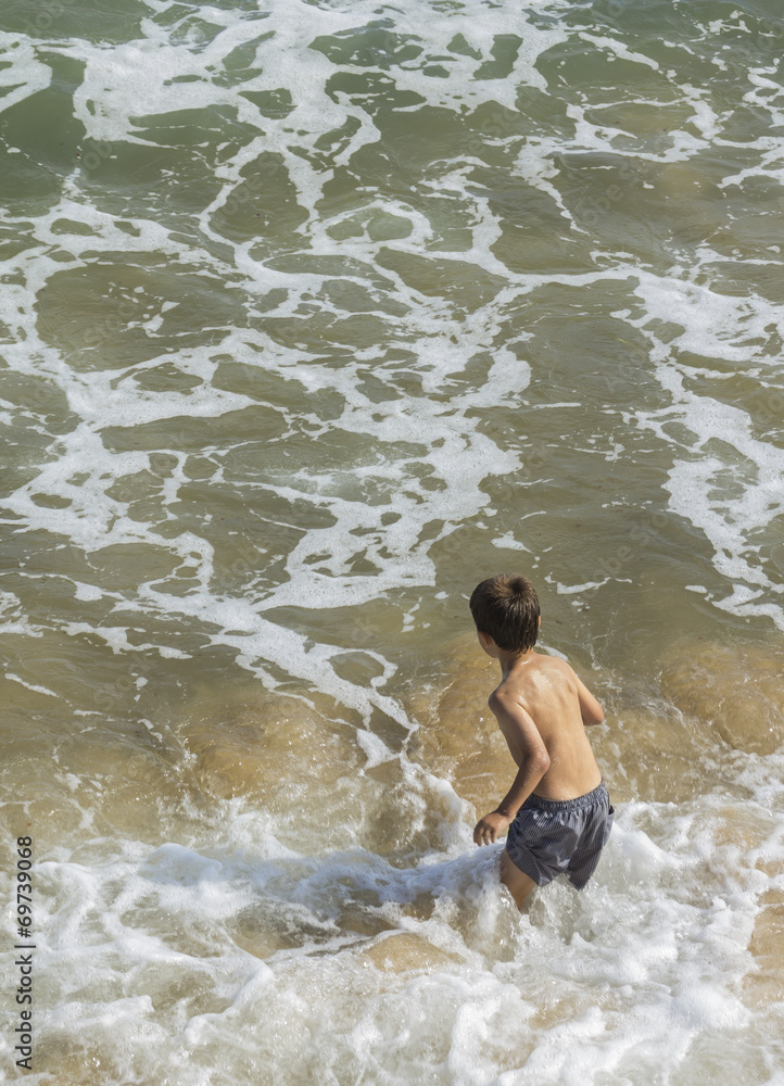Fototapeta premium niño jugando en el mar