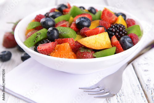 Fototapeta Naklejka Na Ścianę i Meble -  Delicious fruits salad in plate on table close-up