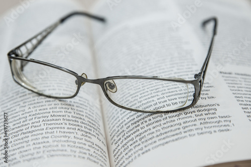 Close up eyeglasses on a document on brown floor