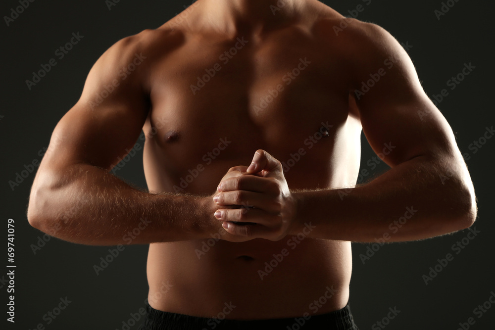 Fototapeta premium Handsome muscle young man on dark background