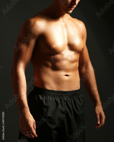 Handsome muscle young man on dark background