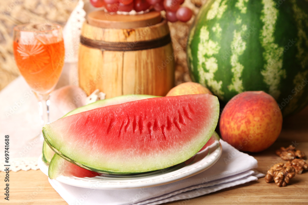 Composition of ripe watermelon, fruits, pink wine in glass and