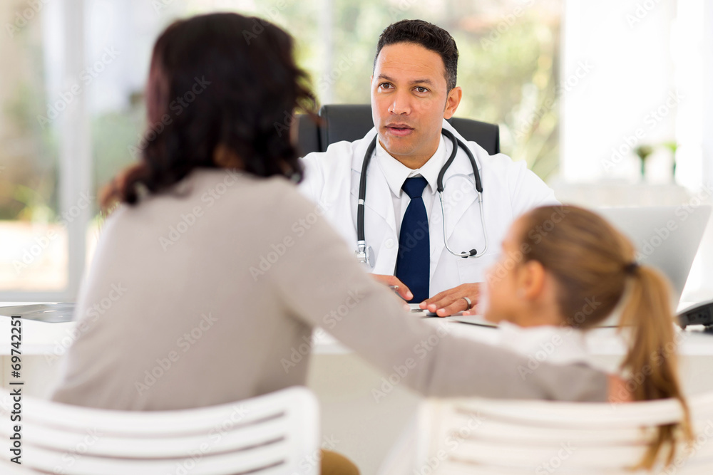 paediatrician consulting patient in office