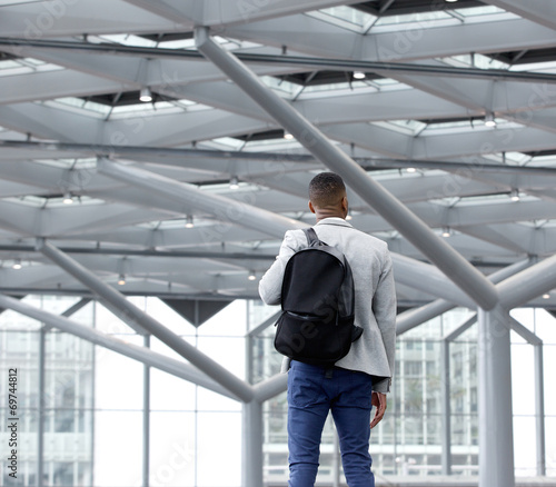 Wallpaper Mural Young man standing in empty airport Torontodigital.ca