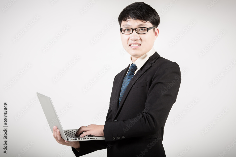 Asian business man using laptop computer isolated on white backg Asian business man using laptop computer isolated on white backg