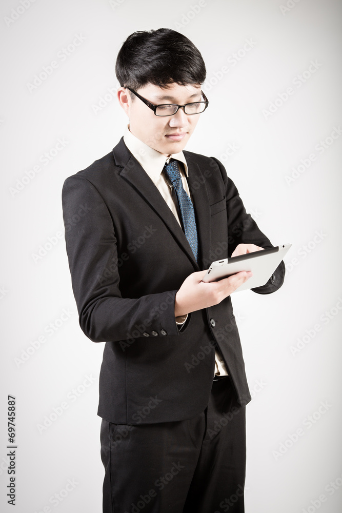 Asian business man using tablet computer isolated on white backg Asian business man using tablet computer isolated on white backg