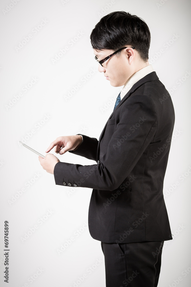 Asian business man using tablet computer isolated on white backg Asian business man using tablet computer isolated on white backg