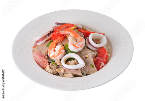 Spicy seafood noodles in white isolated