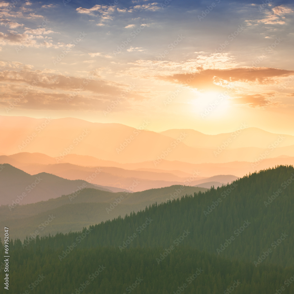 Fototapeta premium Colorful Sunset in the Mountains, hills, sun and sky