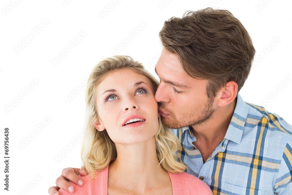 Handsome man kissing girlfriend on cheek Handsome man kissing girlfriend on cheek