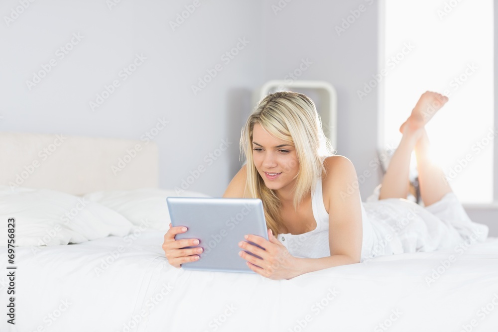 Relaxed beautiful woman using digital tablet in bed Relaxed beautiful woman using digital tablet in bed