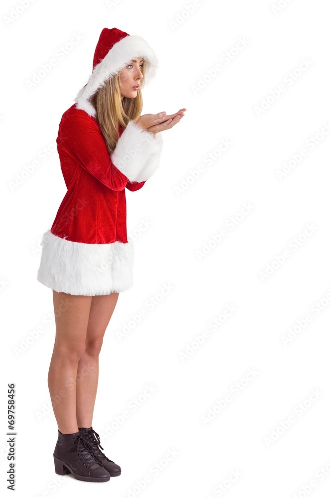 Pretty santa girl blowing over hands Pretty santa girl blowing over hands