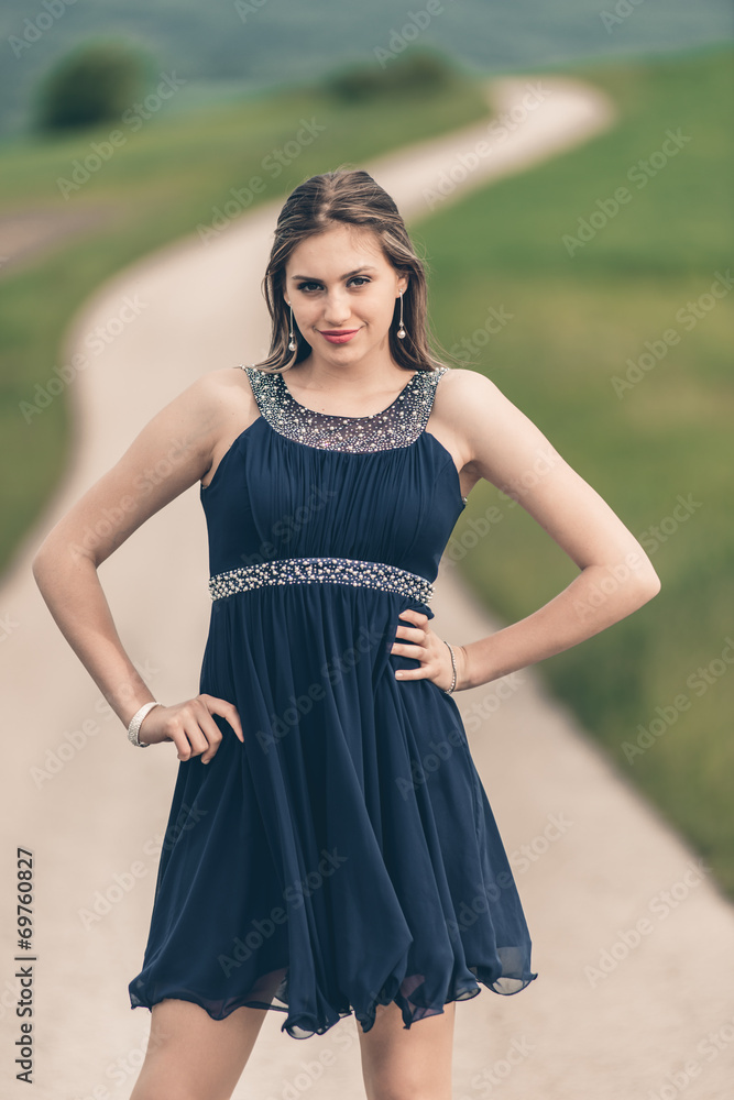 Beautiful young lady posing in a fashion outdoor setting