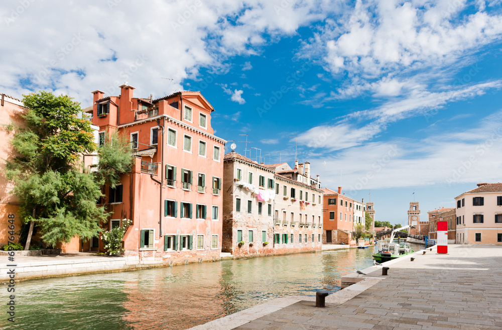 Small canal iwith colorful buildings n the Venice, Italy