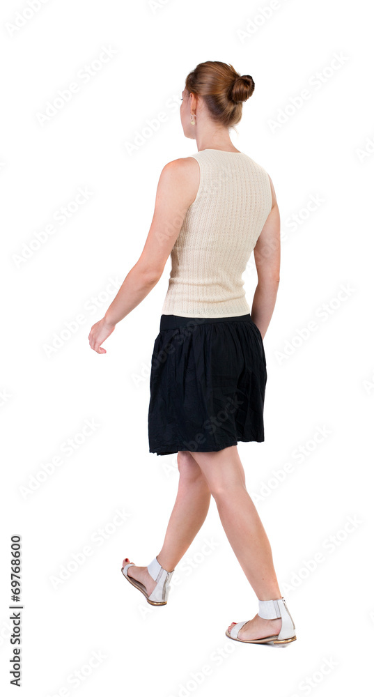back view of walking woman in dress. beautiful blonde girl in m back view of walking woman in dress. beautiful blonde girl in m