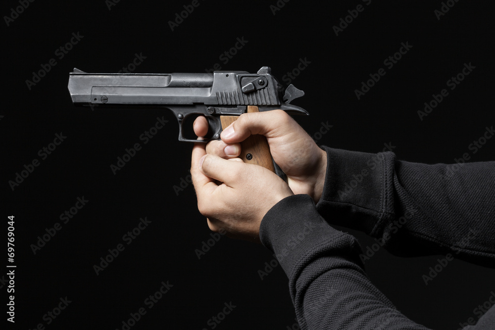 male hands with gun isolated on black background male hands with gun isolated on black background