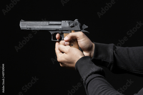 male hands with gun isolated on black background © Tiler84