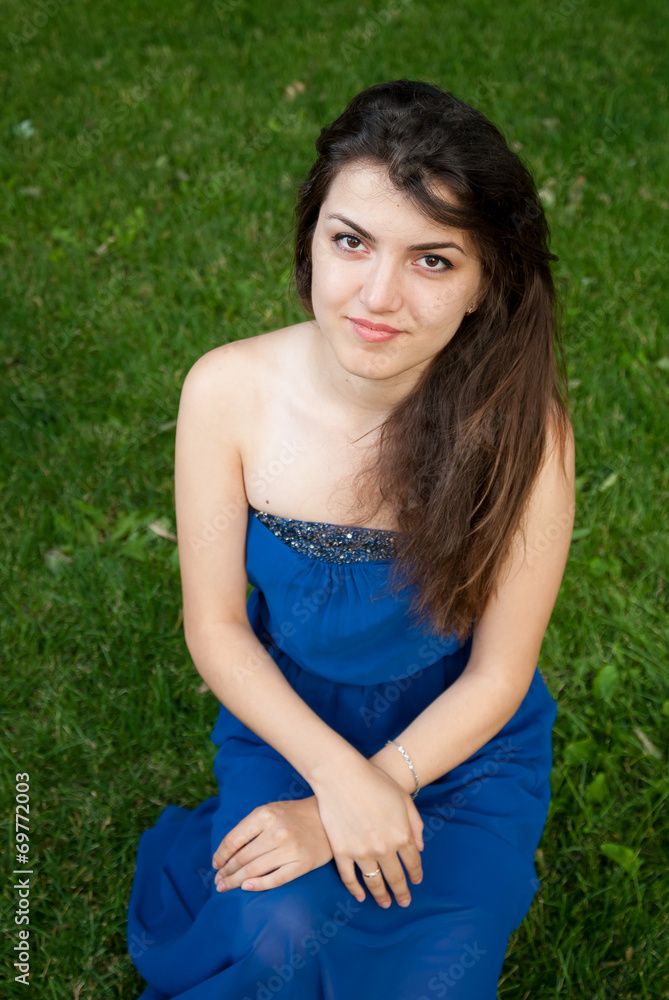Beautiful oriental girl on grass in the park Beautiful oriental girl on grass in the park