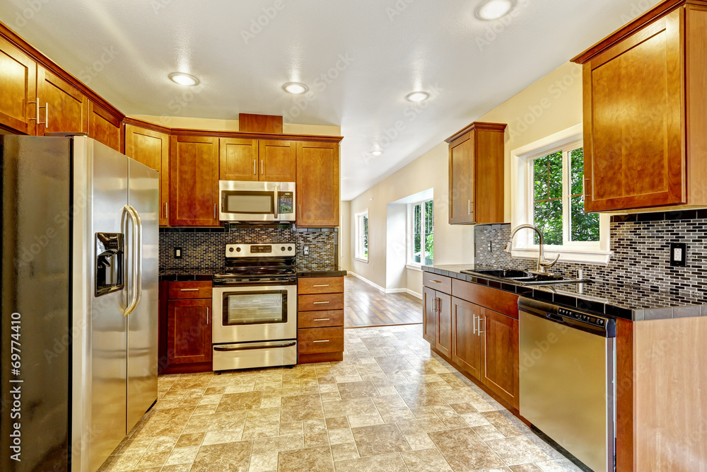Kitchen with black granite tops and wooden cabinets Kitchen with black granite tops and wooden cabinets