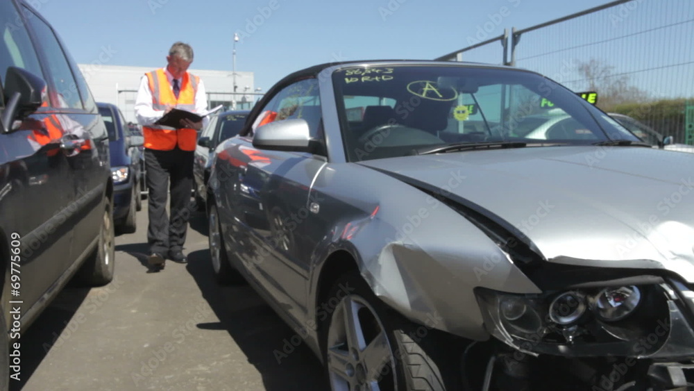 Loss Adjuster Inspecting Car Involved In Accident Loss Adjuster Inspecting Car Involved In Accident