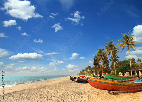 old fishing boats on beach in india photo