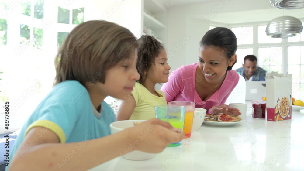 Family Having Breakfast In Kitchen Together Family Having Breakfast In Kitchen Together
