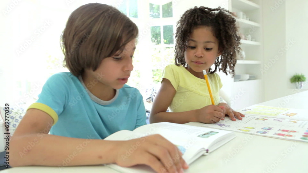 Two African American Children Doing Homework In Kitchen Two African American Children Doing Homework In Kitchen