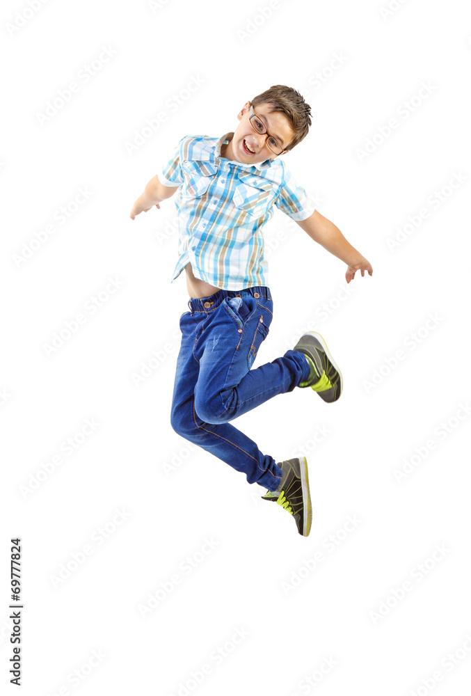 Little boy jumping on white background