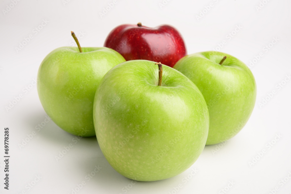 Green apples with one red.