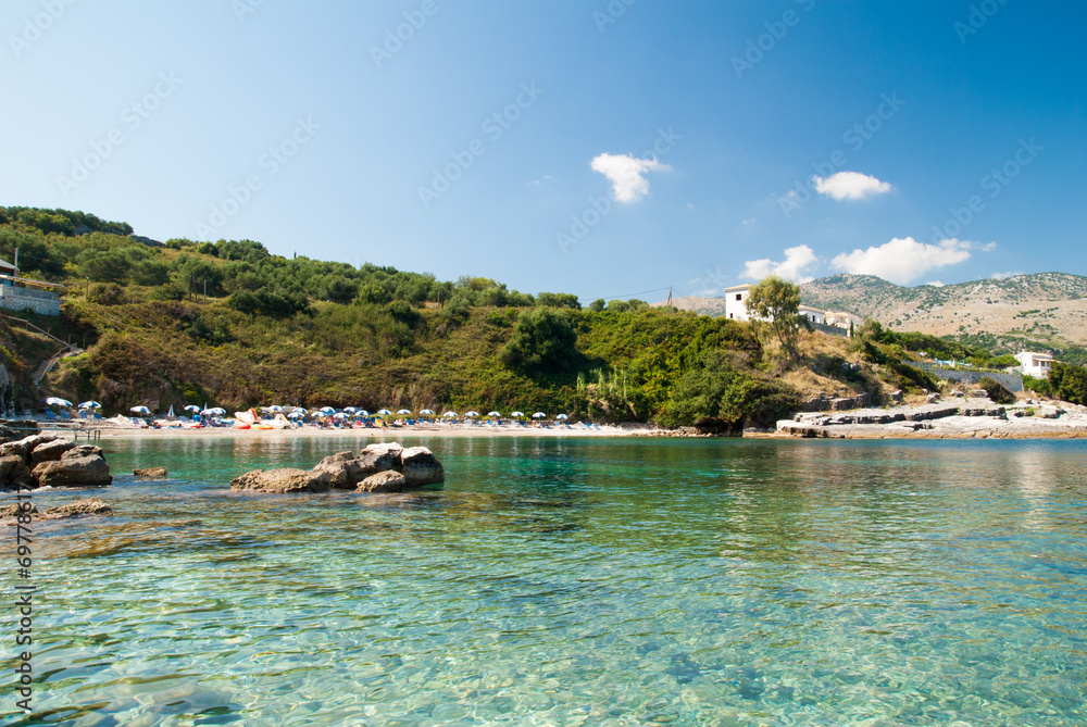 Kassiopi Beach, Corfu Island, Greece. Sunbeds and umbrellas