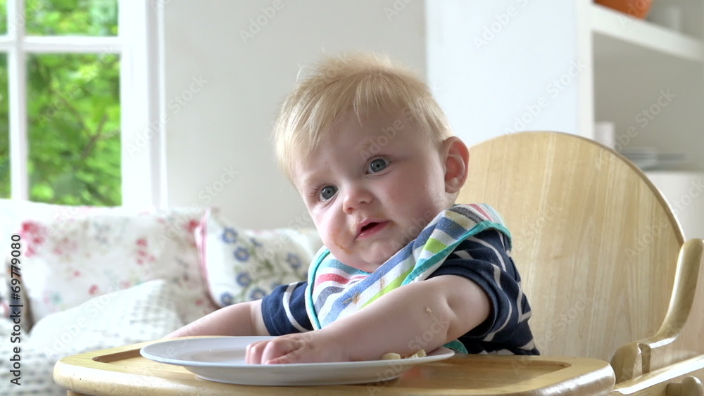 Baby Boy Eating Meal In In High Chair Baby Boy Eating Meal In In High Chair