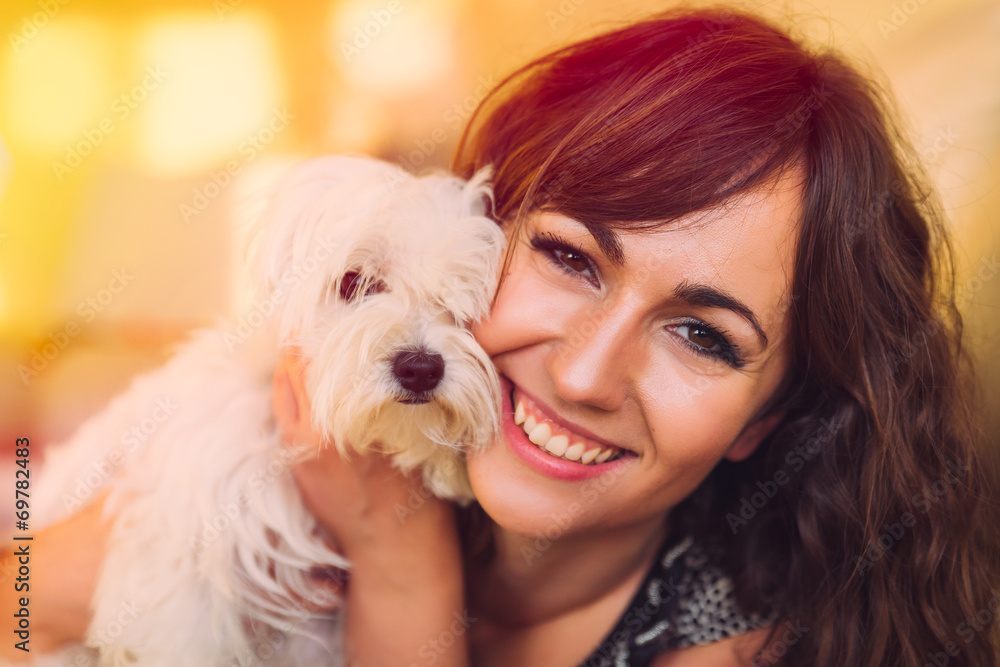 Beautiful happy woman cuddling her pet dog Beautiful happy woman cuddling her pet dog