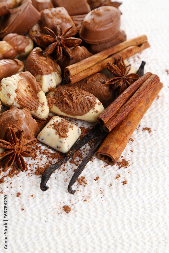 Different kinds of chocolates with spices on white background Different kinds of chocolates with spices on white background