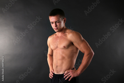 Handsome muscle young man on dark background