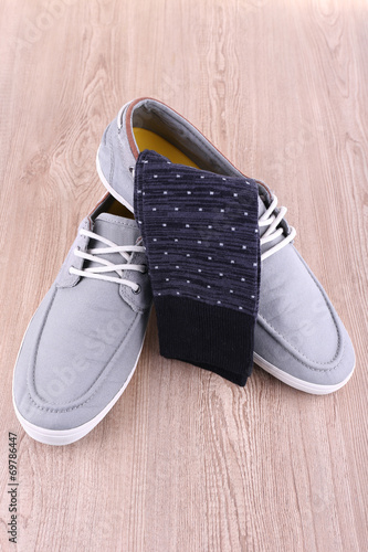 Top-siders and socks on wooden background photo