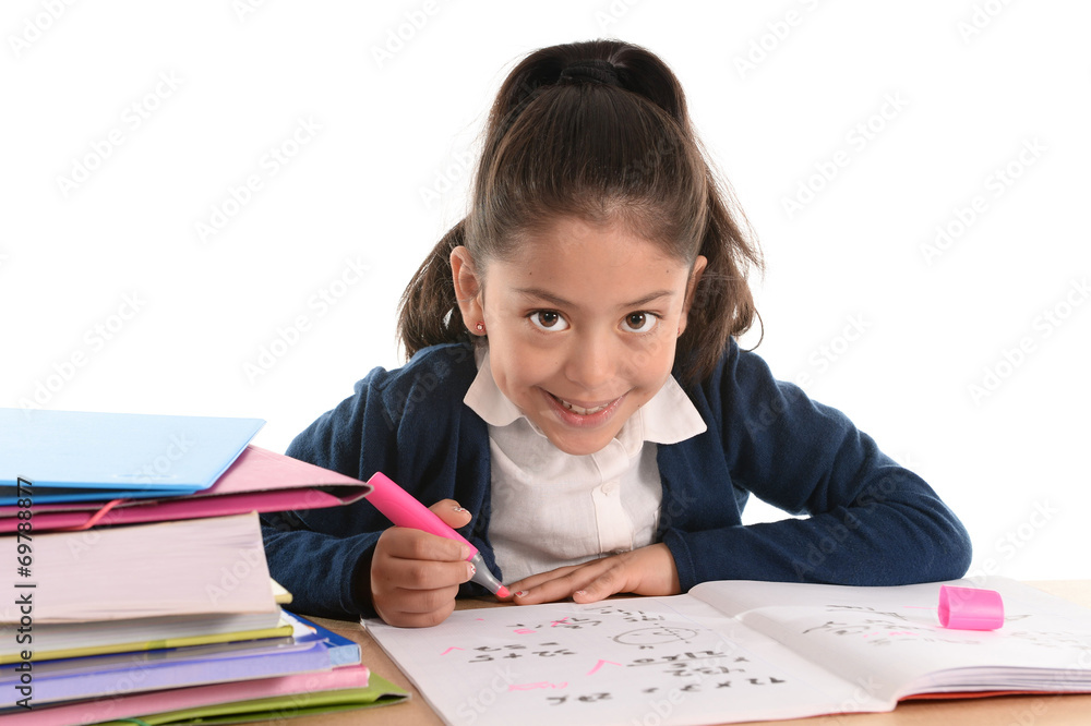 happy latin child sitting on desk doing homework and smiling happy latin child sitting on desk doing homework and smiling