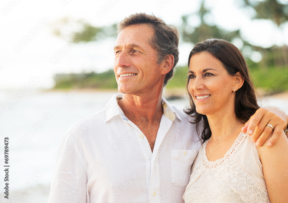 Mature Couple Enjoying Sunset on the Beach Mature Couple Enjoying Sunset on the Beach