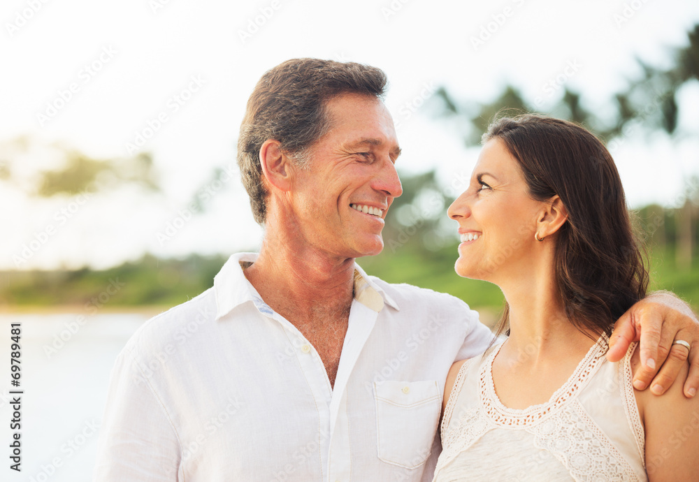 Mature Couple Enjoying Sunset on the Beach Mature Couple Enjoying Sunset on the Beach