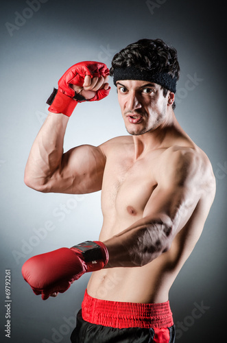 Muscular boxer wiith red gloves © Elnur