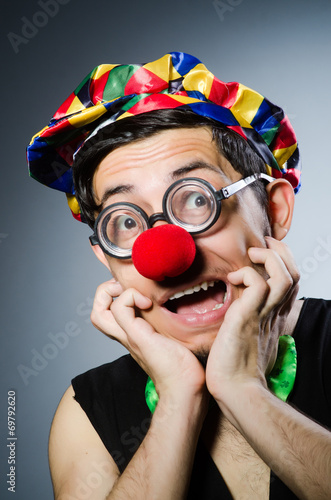 Funny clown against the dark background