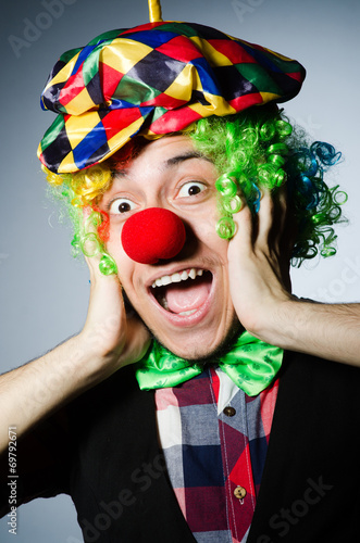 Funny clown against the dark background