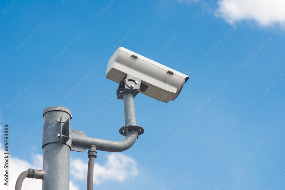 CCTV Security camera in sky background CCTV Security camera in sky background